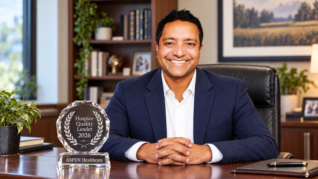 Sukhu George, CEO of Aspen Healthcare with a Hospice Quality Leader award.